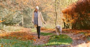How Highly Sensitive People Can Set Healthy Emotional Boundaries Without Feeling Guilty woman walking dog in nature